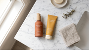 Moisturiser and sunscreen shown together in a flat lay image to explain which goes on first in skincare routine