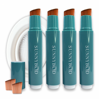The Sun Seeker Family Bundle. The picture shows four SUNNYBOD™ Refillable Sunscreen Applicator side by side. The brush is turquoise. The handle has the word "SUNNYBOD" written in white capital letters. The brush is placed on a white background. Also in the picture are the included susncreen brush accessories. These are two SUNNYBOD™ Replacment Brush Heads and a white SUNNYBOD™ Silicone Brush Cleaning Bowl.