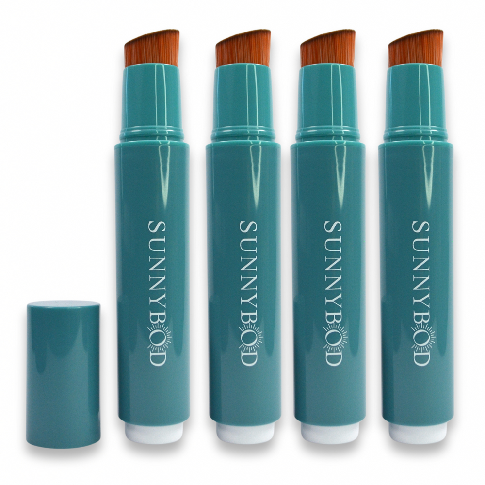 The picture shows The Family Pack. Four SUNNYBOD™ Refillable Sunscreen Brush Applicators standing side by side. The brush is turquoise. The susncreen brush bristles are light brown. The handle has the word "SUNNYBOD" written in white capital letters. There is also a turquoise cap next to the brush that can be placed on the brush to cover the bristles. The brush is placed on a white background.